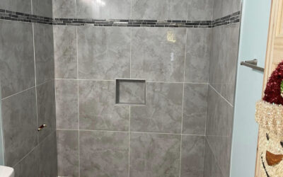 Tiled shower floor and walls.